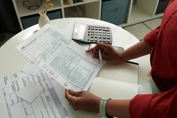 Person reviewing a structured personal financial planning document at a desk