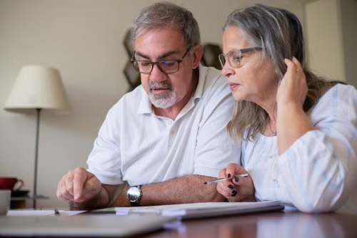 Older couple reviewing retirement planning documents